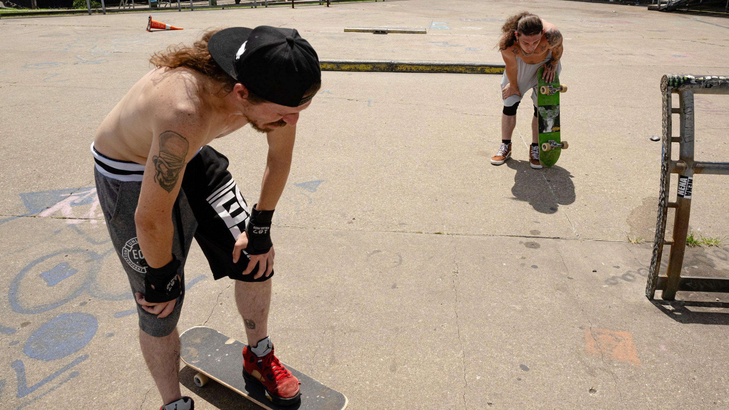 Skateboarders Anthony Eadens and Tommy Wright catch their breath after skating at the Dave Armstrong Extreme Park on Sunday, June 22, 2025, in Louisville, Ky. (AP Photo/Jon Cherry)