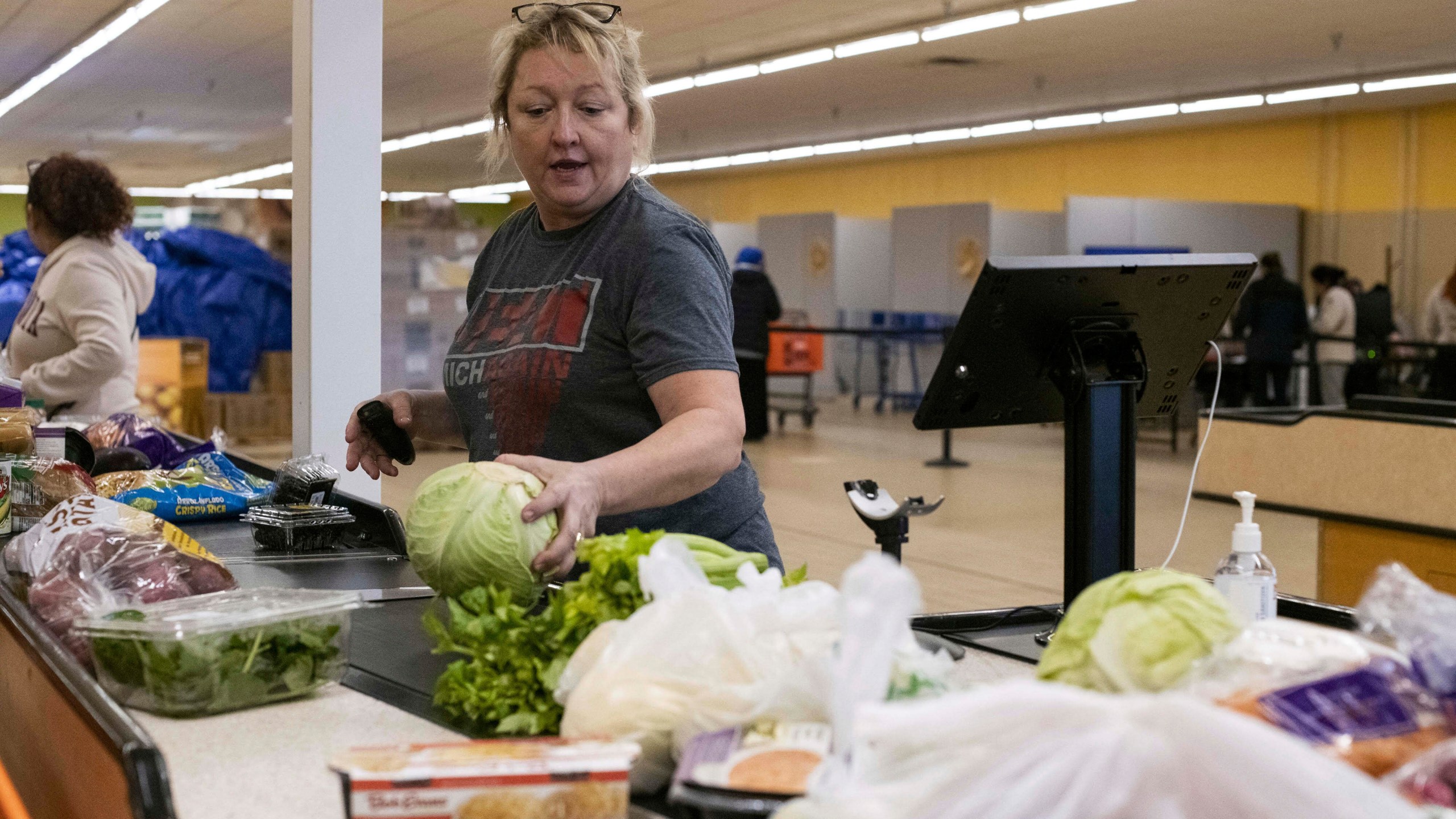 In this photo provided by Mid-Ohio Food Collective, volunteer Guyanna Slater from Mid-Ohio Food Collective, helps customers shop for free food at the Mid-Ohio Market in early June 2025, in Grove City, Ohio. (Mid-Ohio Food Collective via AP)