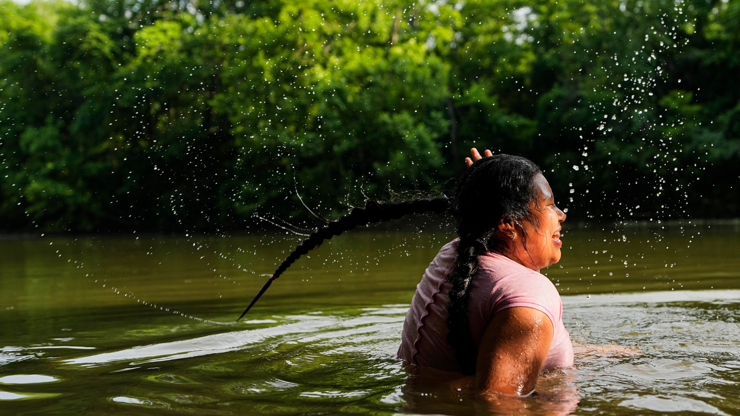 Sevlin Mendez cools off in the Harpeth River as the heat index reaches 100 degrees Fahrenheit, Wednesday, June 25, 2025, in Nashville, Tenn. (AP Photo/George Walker IV)