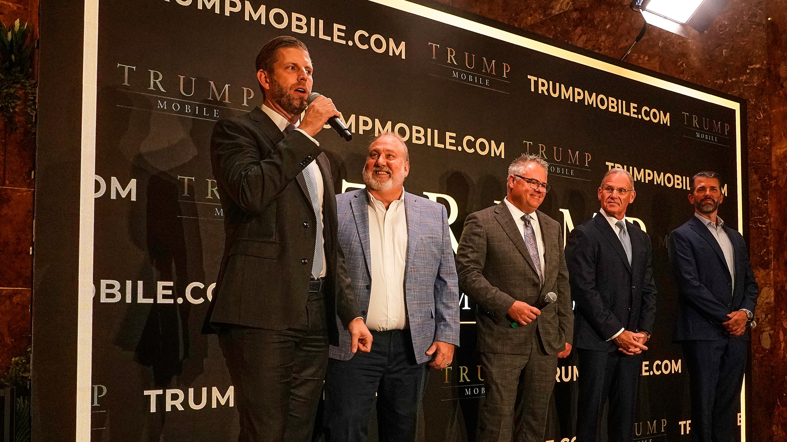 Eric Trump, Don Hendrickson, Eric Thomas, Patrick O'Brien and Donald Trump Jr., left to right, participate in the announcement of Trump Mobile, in New York's Trump Tower, Monday, June 16, 2025. (AP Photo/Richard Drew)