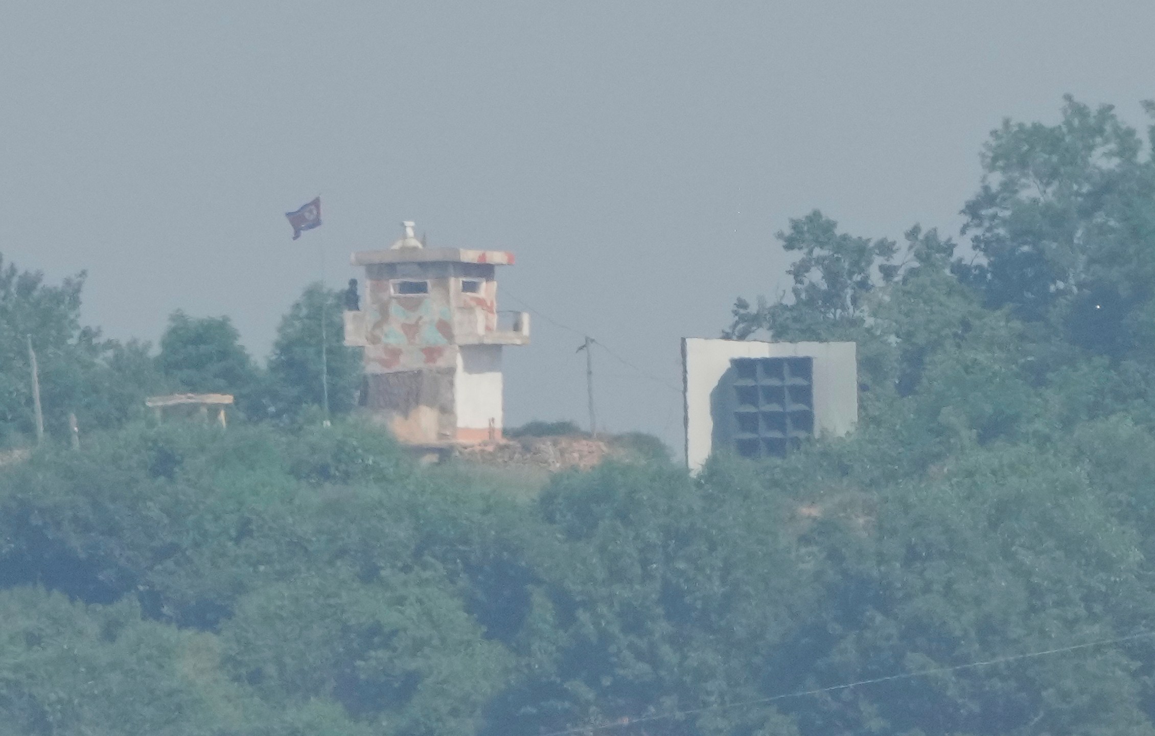FILE - A North Korean military guard post, left, and loudspeaker are seen from Paju, South Korea, near the border with North Korea, June 12, 2025. (AP Photo/Ahn Young-joon, File)