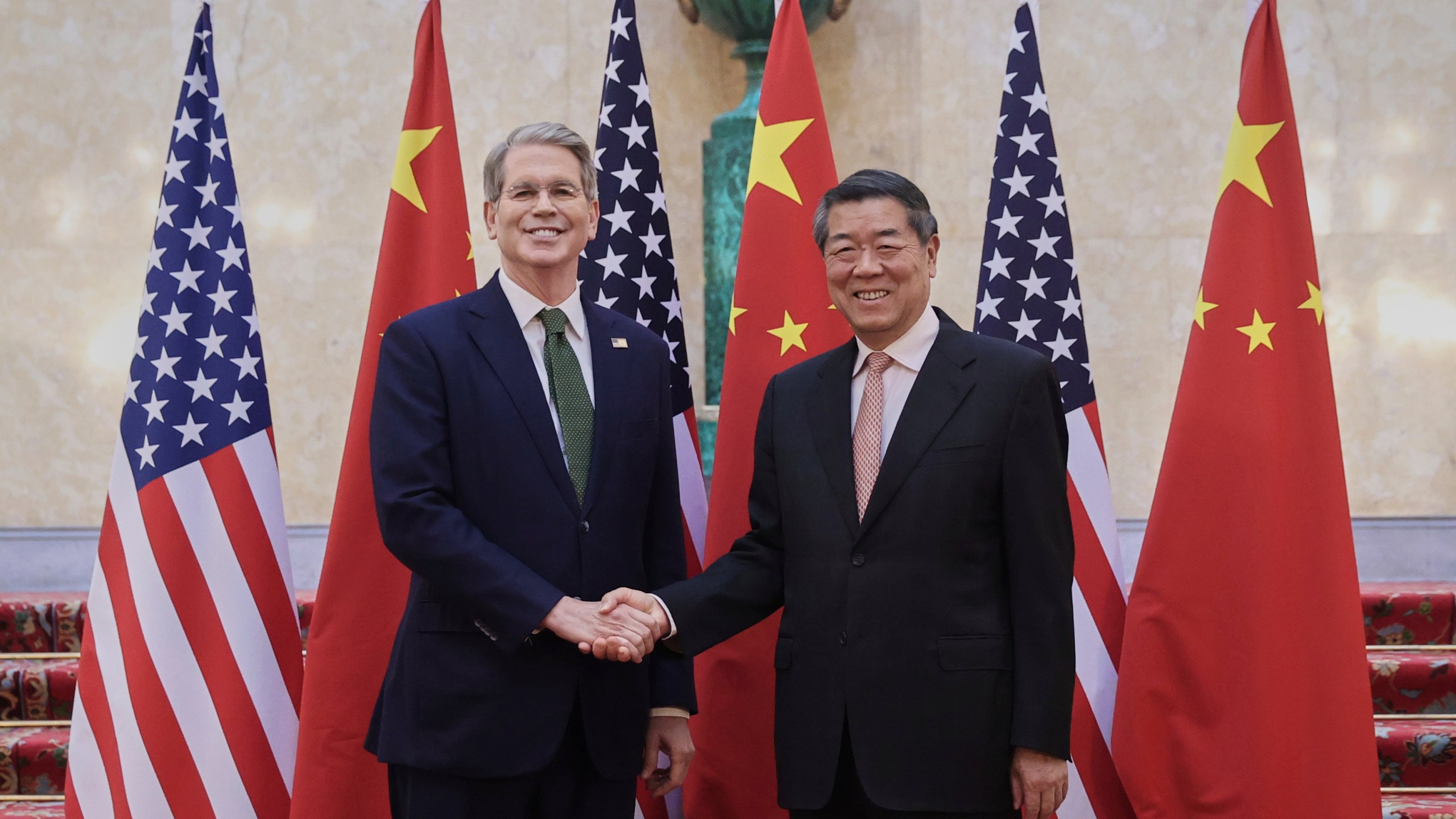 In this photo released by Xinhua News Agency, Chinese Vice Premier He Lifeng, right, shakes hands with U.S. Treasury Secretary Scott Bessent before their meeting to discuss China-U.S. trade, in London, Monday, June 9, 2025. (Li Ying/Xinhua via AP)