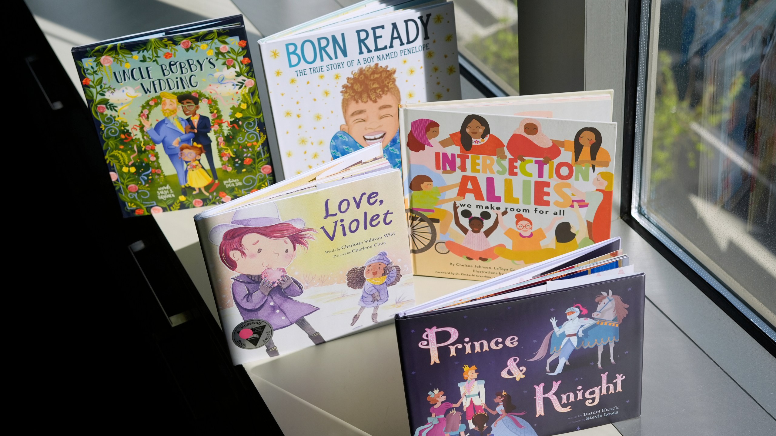 FILE - A selection of books featuring LGBTQ characters that are part of a Supreme Court case are pictured, April, 15, 2025, in Washington. (AP Photo/Pablo Martinez Monsivais, File)