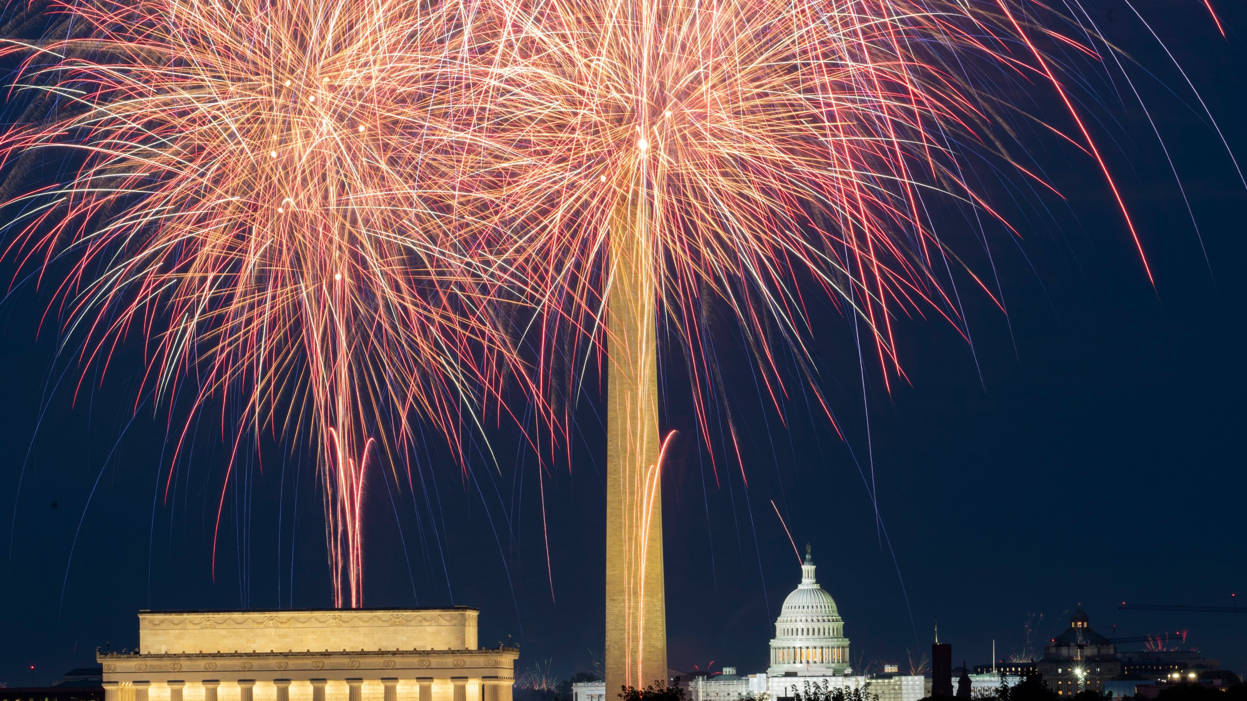 FILE - Fireworks burst above the National Mall and, from left, the Lincoln Memorial, Washington Monument and the U.S. Capitol building, during Independence Day celebrations in Washington on July 4, 2023. (AP Photo/Stephanie Scarbrough, File)