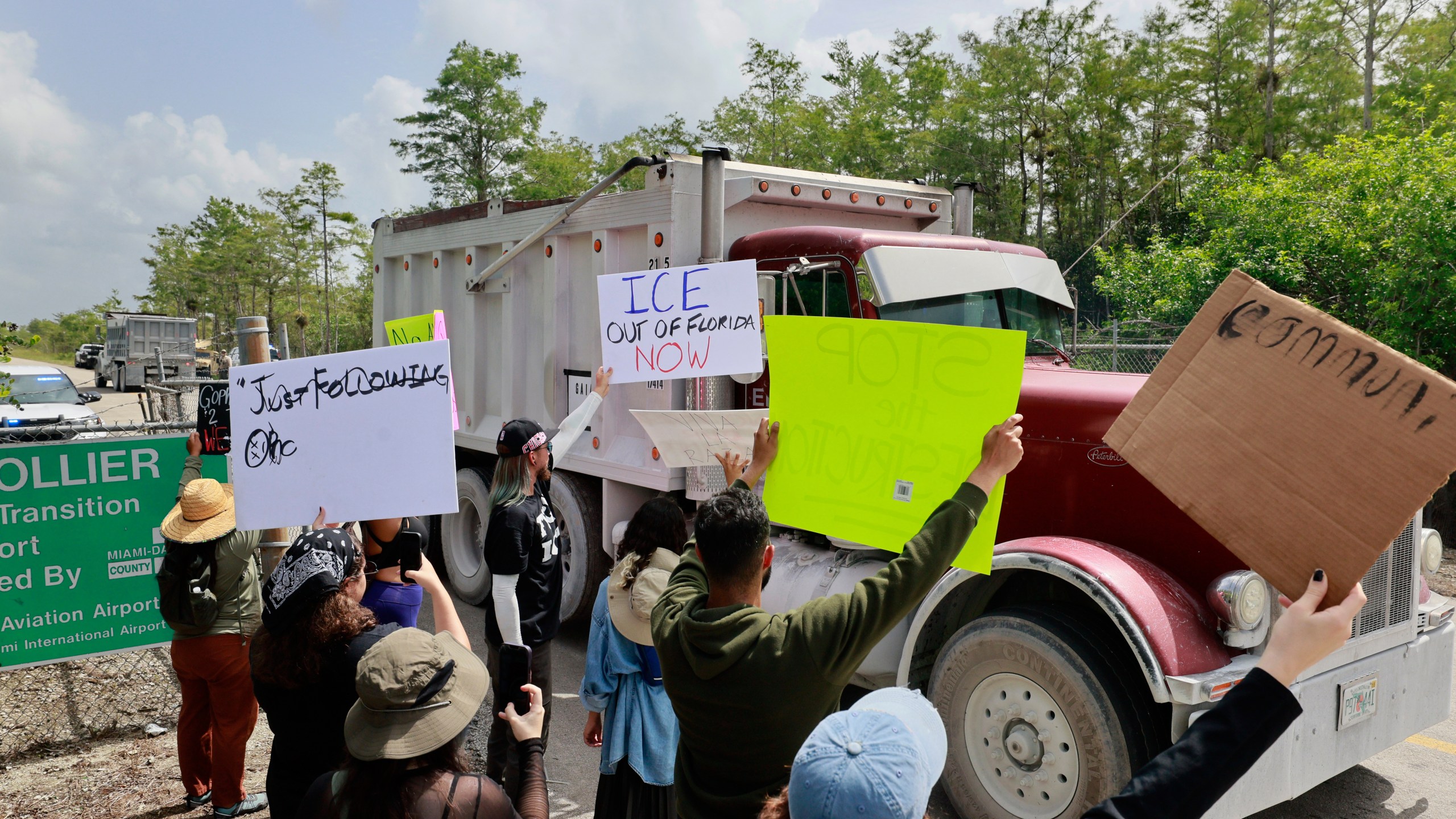 Environmental advocates and protesters at the Dade-Collier Training and Transition Airport on Tamiami Trail E, Ochopee, Fla., on Saturday, June 28, 2025, object to the "Alligator Alcatraz" being built at the facility. (Mike Stocker /South Florida Sun-Sentinel via AP)