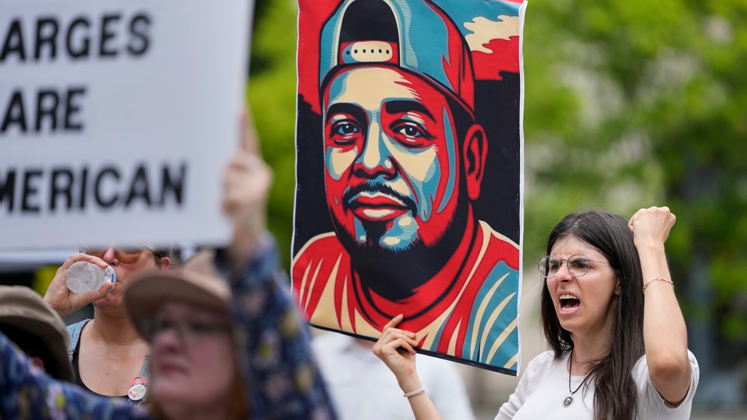 Brianna O'Keefe yells as she holds a portrait of Kilmar Obrego Garcia during a protest outside the federal courthouse Wednesday, June 25, 2025, in Nashville, Tenn. (AP Photo/George Walker IV)