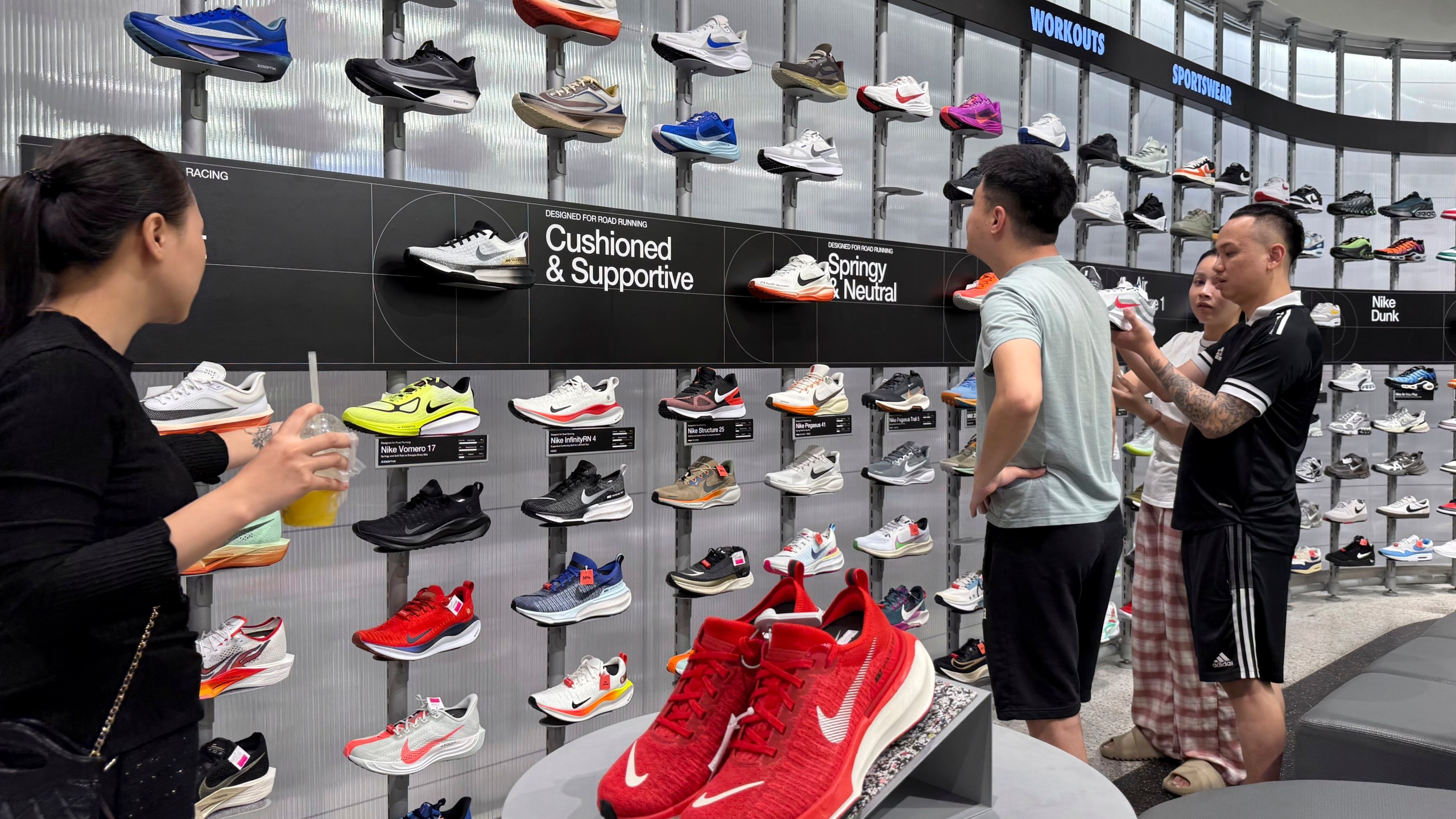 Customers shop for shoes at a Nike shop