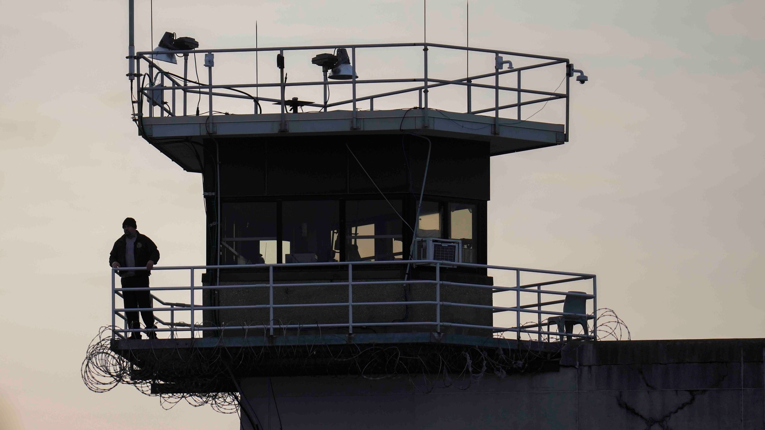 guard stands in a prison tower
