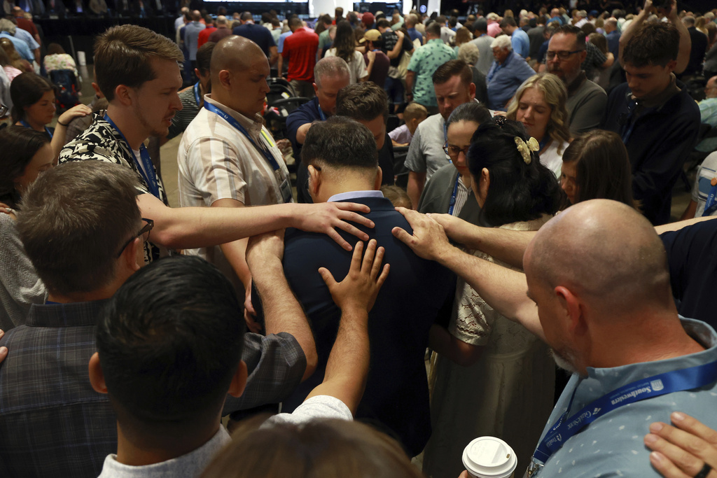 Messengers lay on hands and pray over missionaries