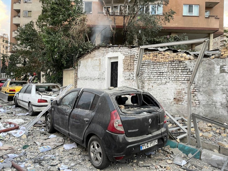 Debris from an apartment building atop parked cars
