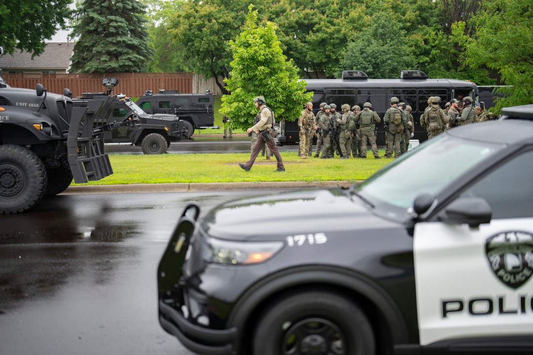 Police offficers gather on the street after a shooting