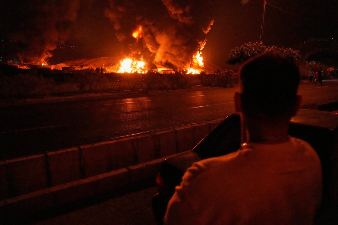 Flames rise from an oil storage facility after in Tehran, Iran.