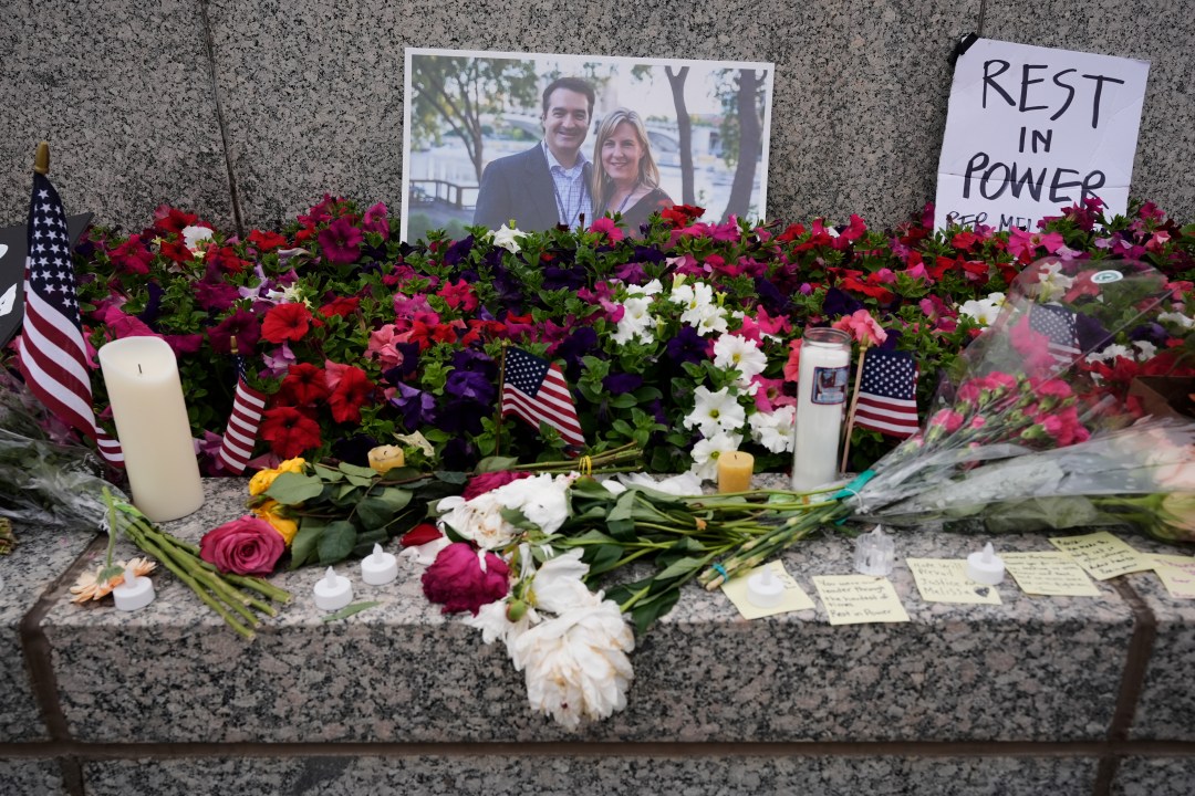 A memorial with flowers, photos and candles at the state Capitol in Minnesota