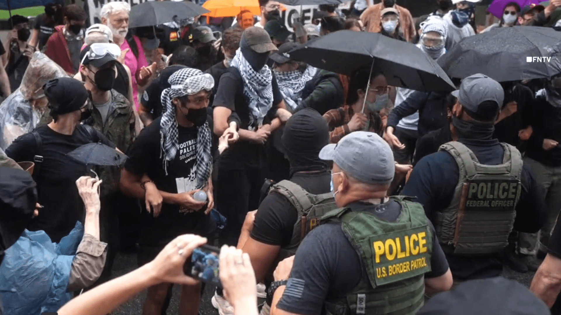 police officers face off with protesters wearing masks
