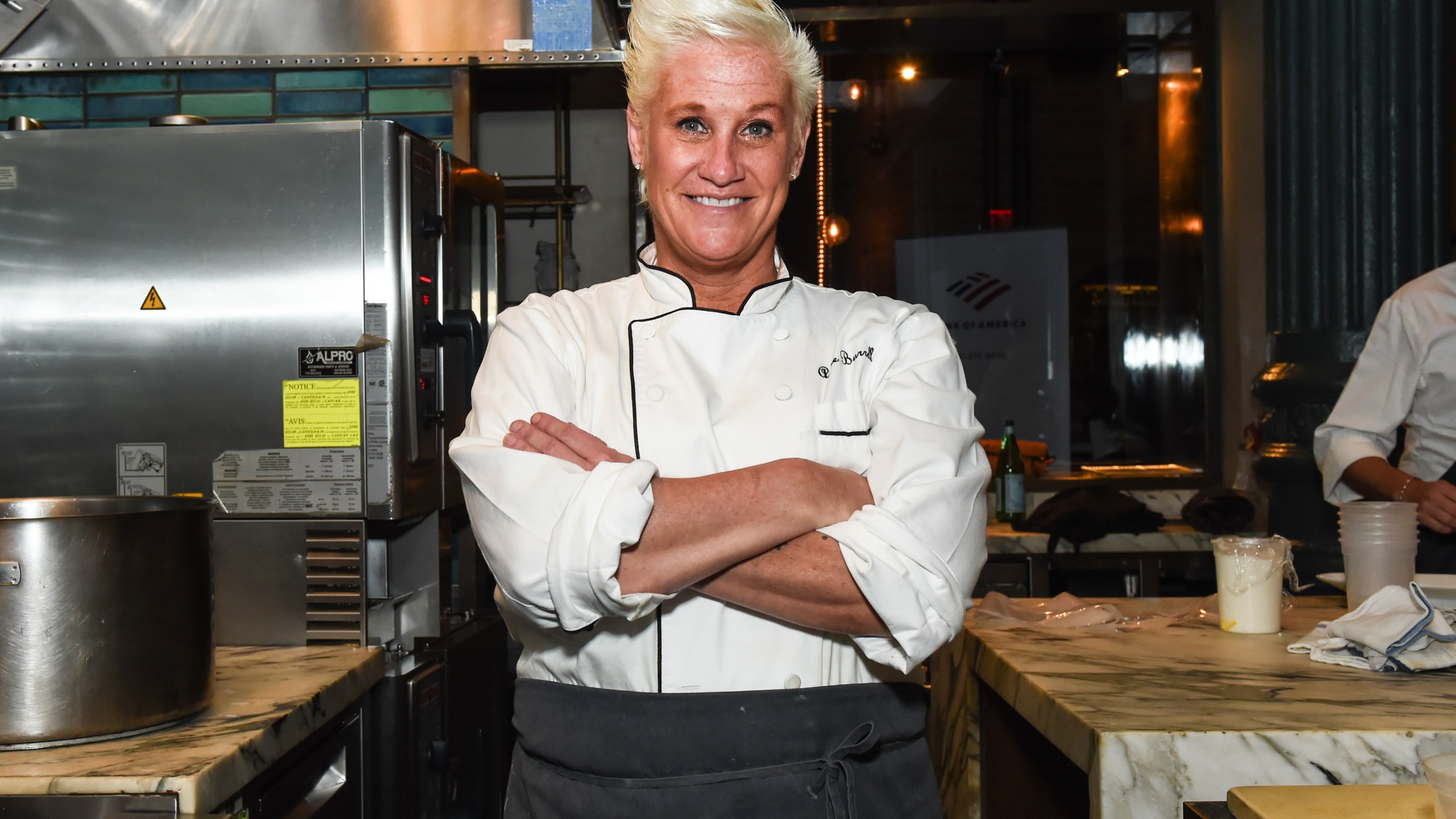Chef Anne Burrell poses in a kitchen for Food Network promotion