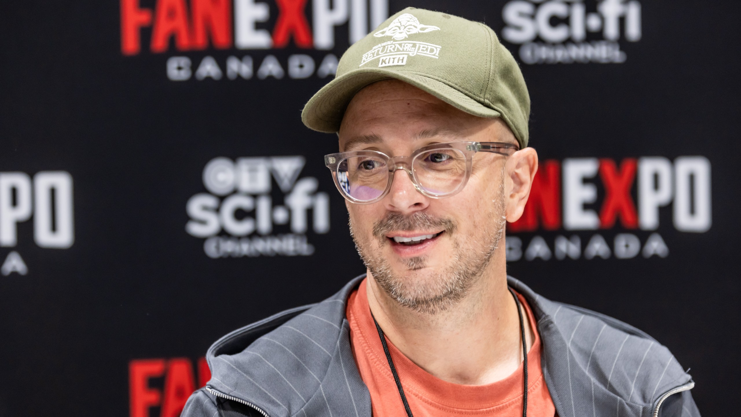 Steve Burns smiling, wearing baseball cap and glasses