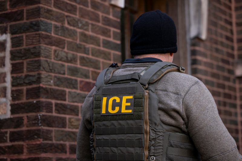 ICE agent seen from behind