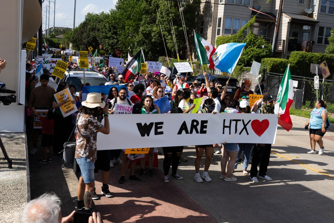 Protesters carry a banner that reads, ''We are HTX"