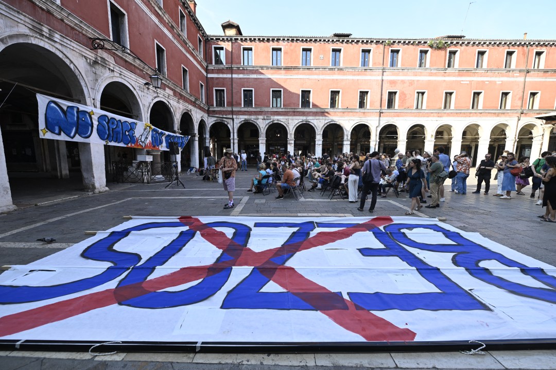Huge sign with Bezos written in blue and a red X through it