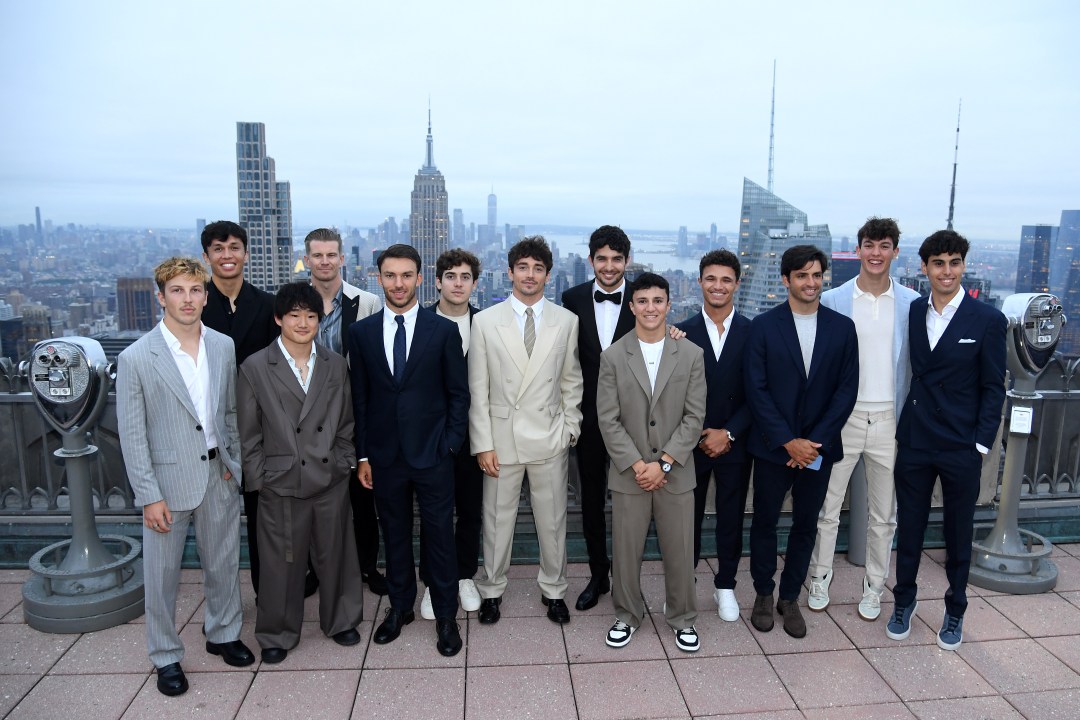 drivers pose for a photo at Rockefeller Center with NYC skyline 