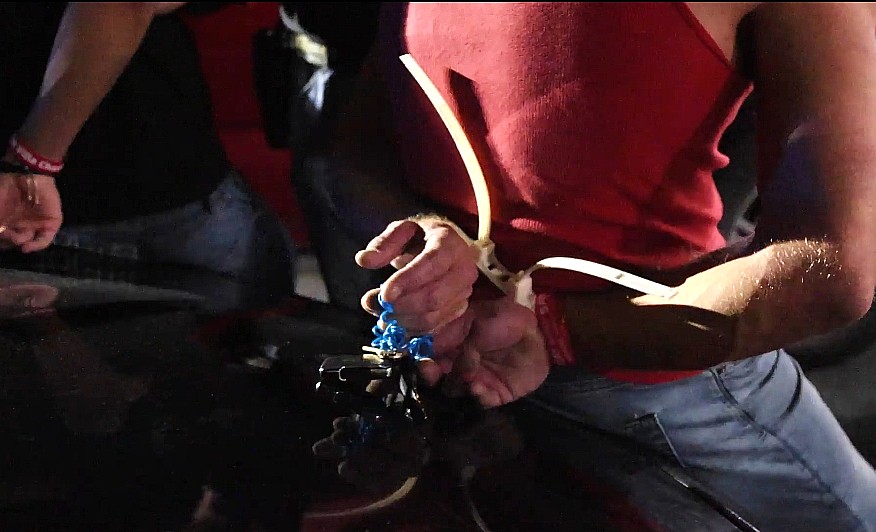 A man's hands are cuffed following a raid June 1, 2025, at a nightclub