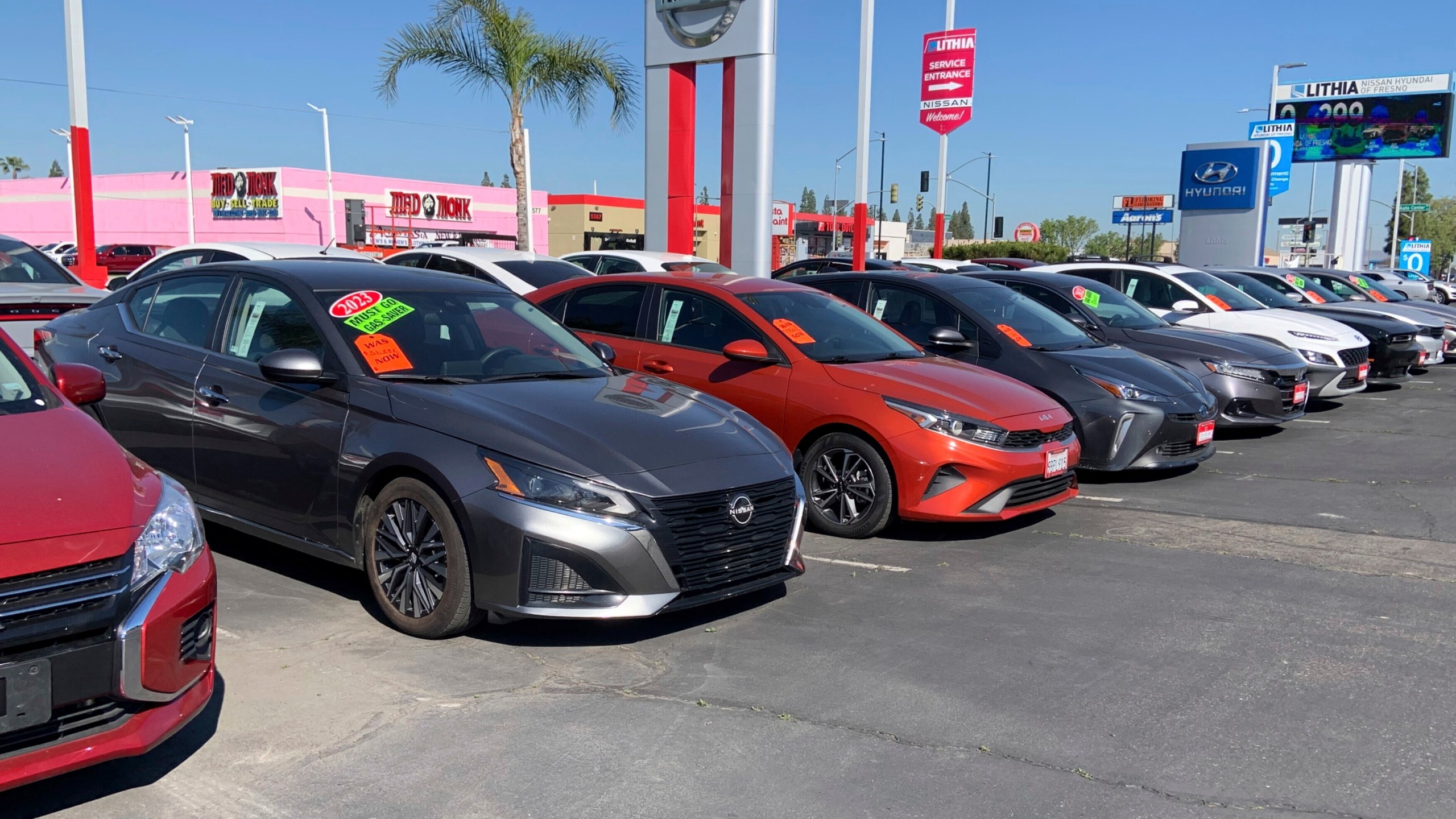 This photo provided by Edmunds shows a lineup of used cars at a Nissan dealership in Fresno, Calif. Used car prices are rising, but being open to alternatives to your ideal car may help uncover better value. (Courtesy of Edmunds via AP)