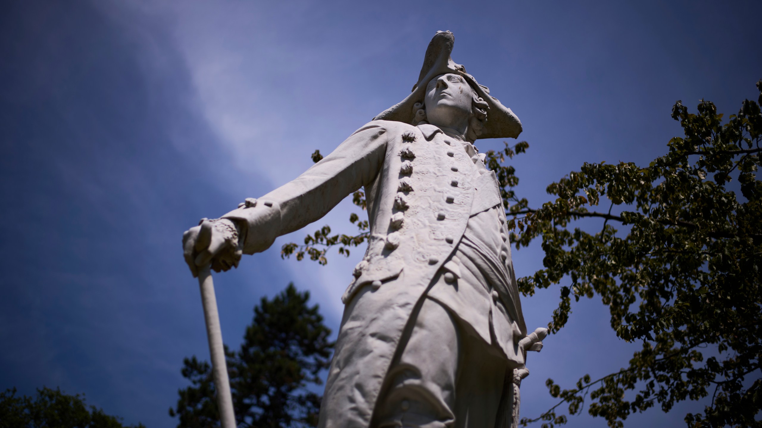 A statue of King Frederick II of Prussia stands in the park of Sanssouci Palace in Potsdam, Germany, June 17, 2025. (AP Photo/Markus Schreiber)