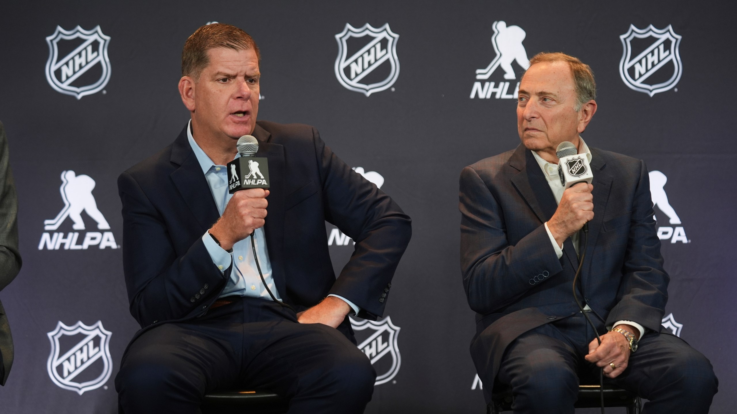 Marty Walsh, left, NHLPA Executive Director, and Gary Bettman, NHL Commissioner, conduct a joint press conference before the NHL hockey draft Friday, June 27, 2025, in Los Angeles. (AP Photo/Damian Dovarganes)