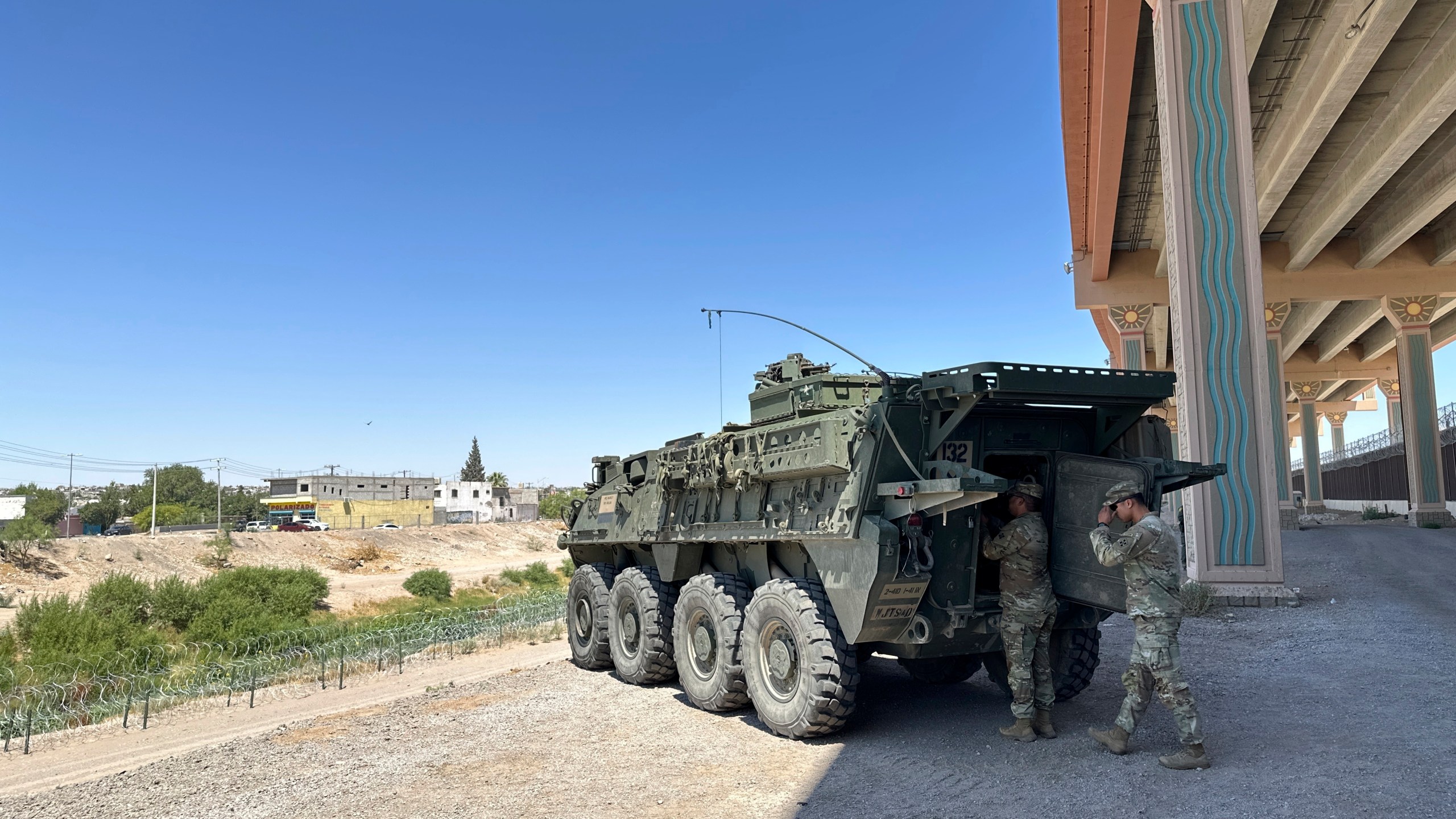 A military transport and surveillance vehicle is parked in a newly designated national defense area on June 11, 2025, along the southern U.S. border in El Paso, Texas. (AP Photo/Morgan Lee)
