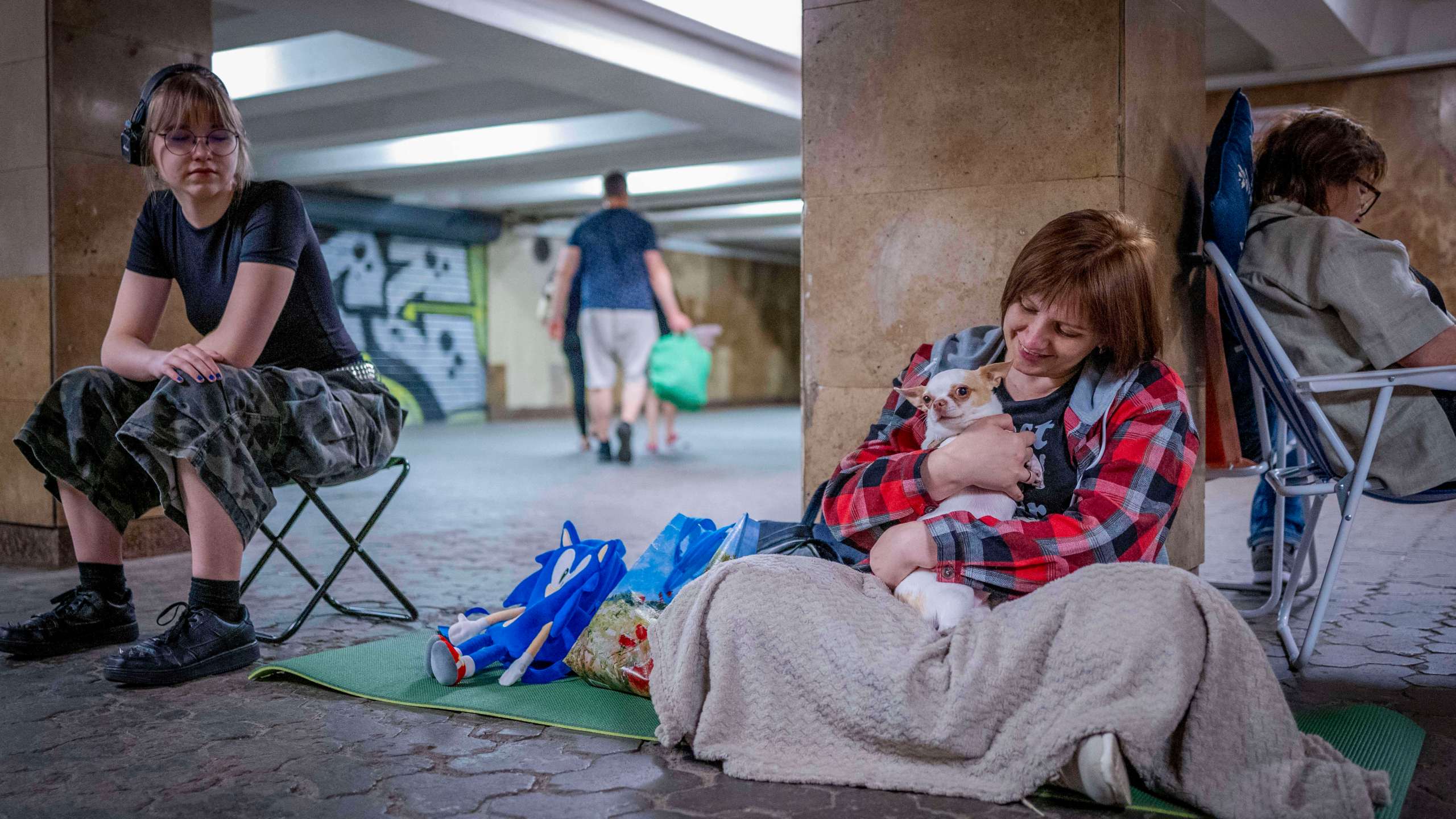 People hide in a metro station, being used as a bomb shelter, during a Russian drones attack in Kyiv, Ukraine, early hours Saturday, July 5, 2025. (AP Photo/Dan Bashakov)