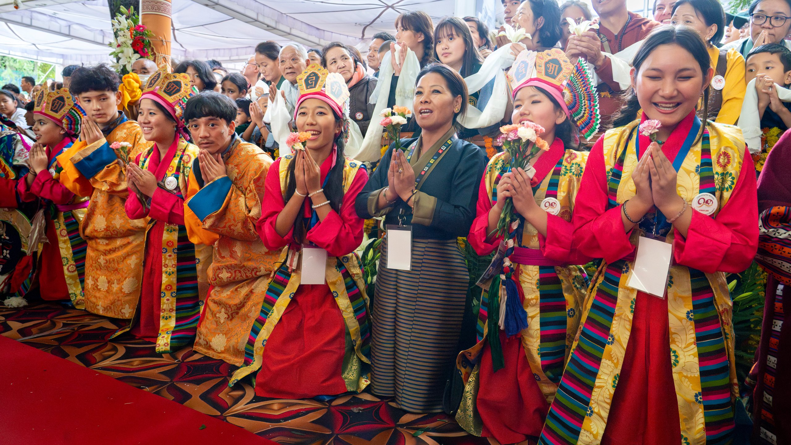 Exiled Tibetans in traditional costumes sing 'Happy Birthday' for their spiritual leader the Dalai Lama, unseen, as he leaves after attending his 90th birthday celebrations at the Tsuglakhang temple in Dharamshala, India, Sunday, July 6, 2025.(AP Photo/Ashwini Bhatia)