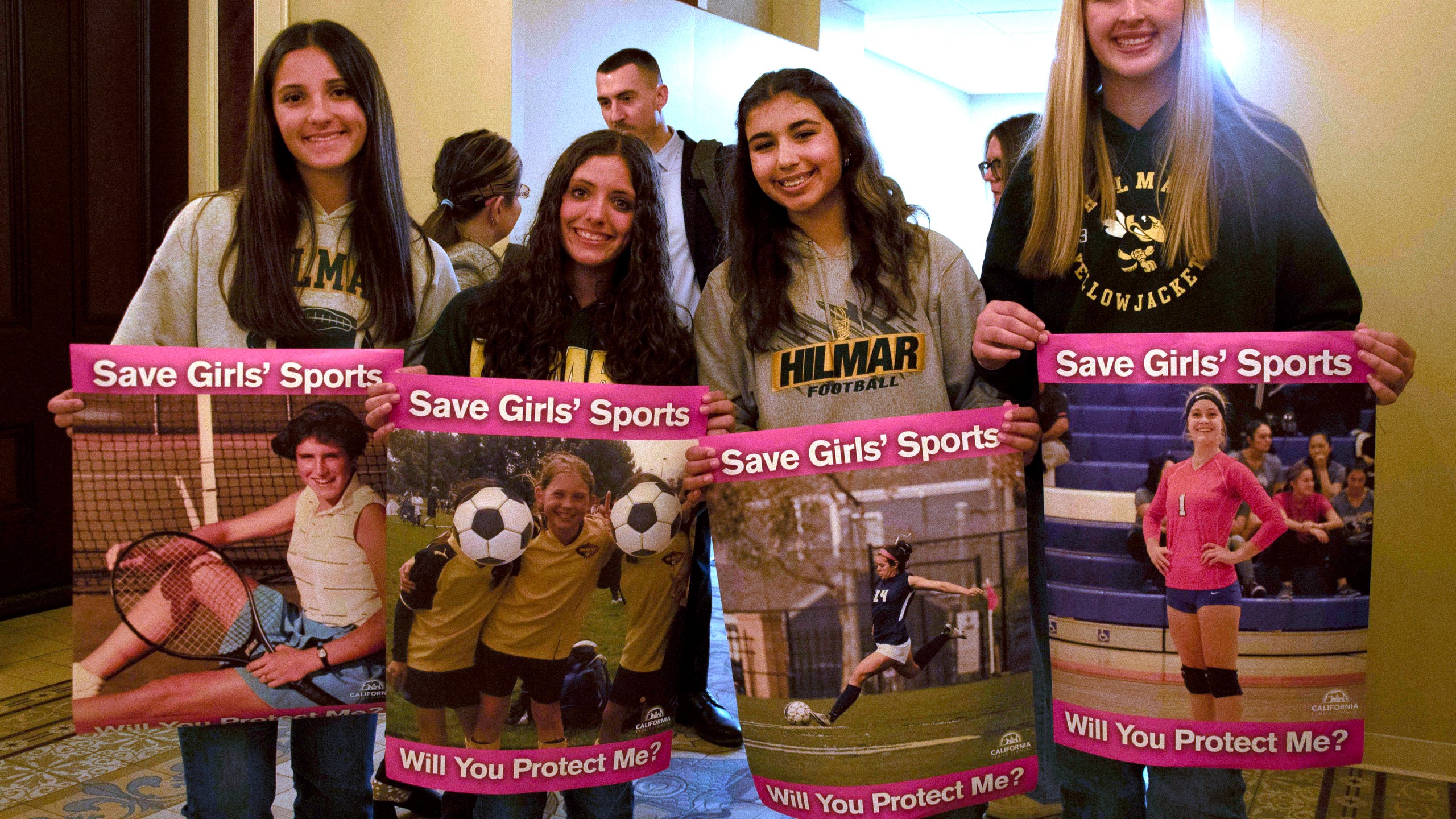 FILE - Student athletes hold signs during a hearing to consider bills to pass rules banning transgender student-athletes, April 1, 2025, in Sacramento, Calif. (AP Photo/Yuri Avila, File)