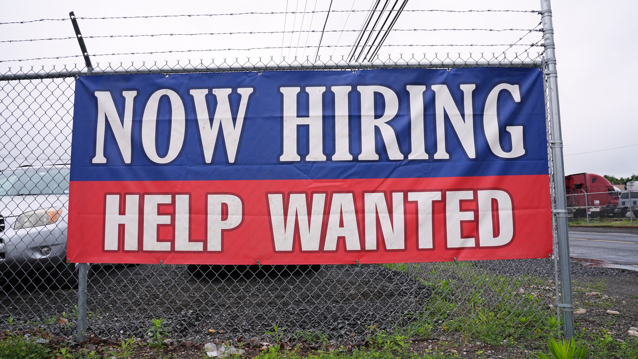 A now hiring and help wanted sign is posted in Morrisville, Pa., Monday, June 9, 2025. (AP Photo/Matt Rourke)