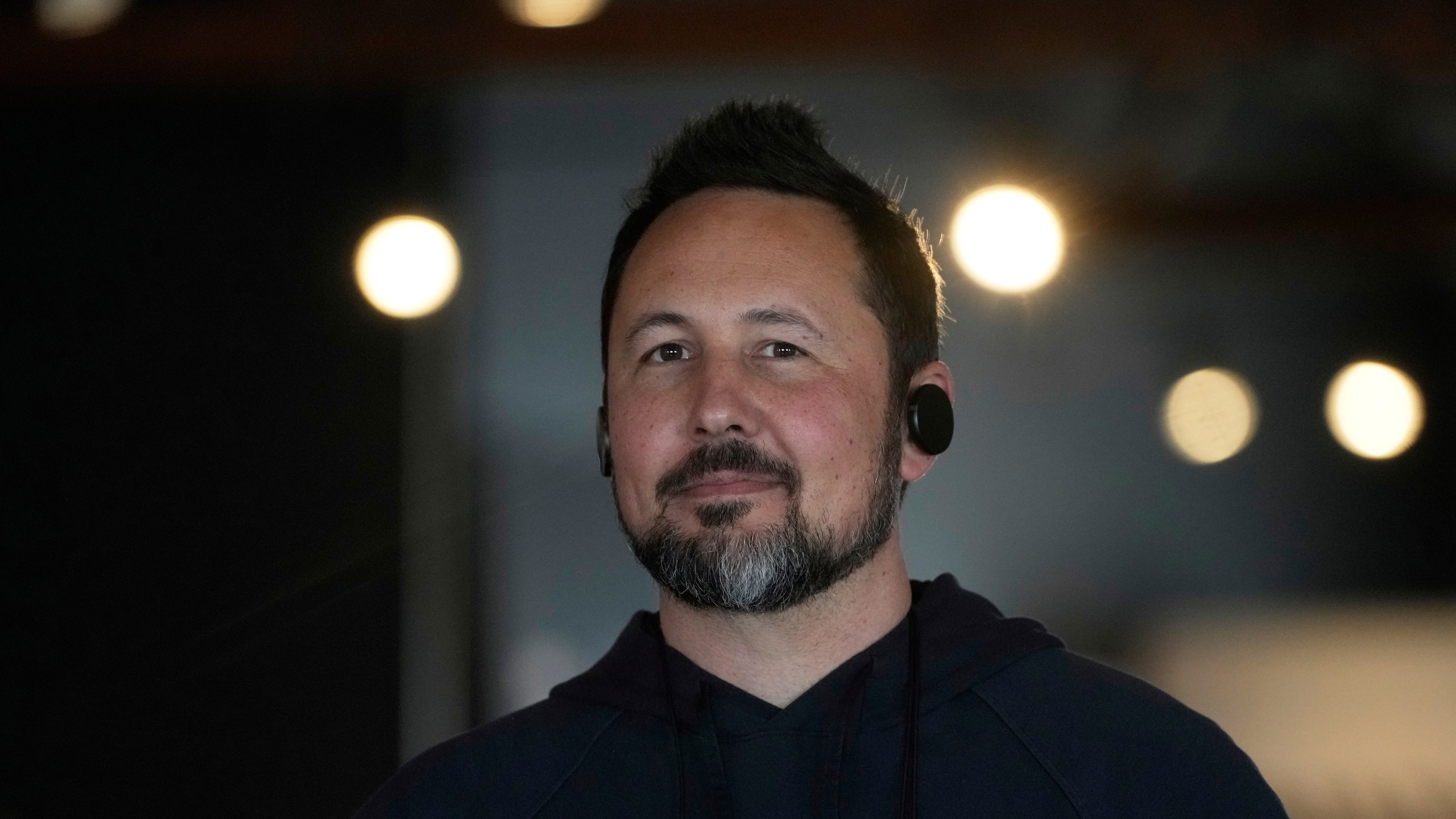 FILE - Jason Rugolo, founder and CEO of iyO, wears the iyO One audio computer in his ears while being interviewed at the company's office in Redwood City, Calif., Tuesday, June 24, 2025. (AP Photo/Jeff Chiu, File)
