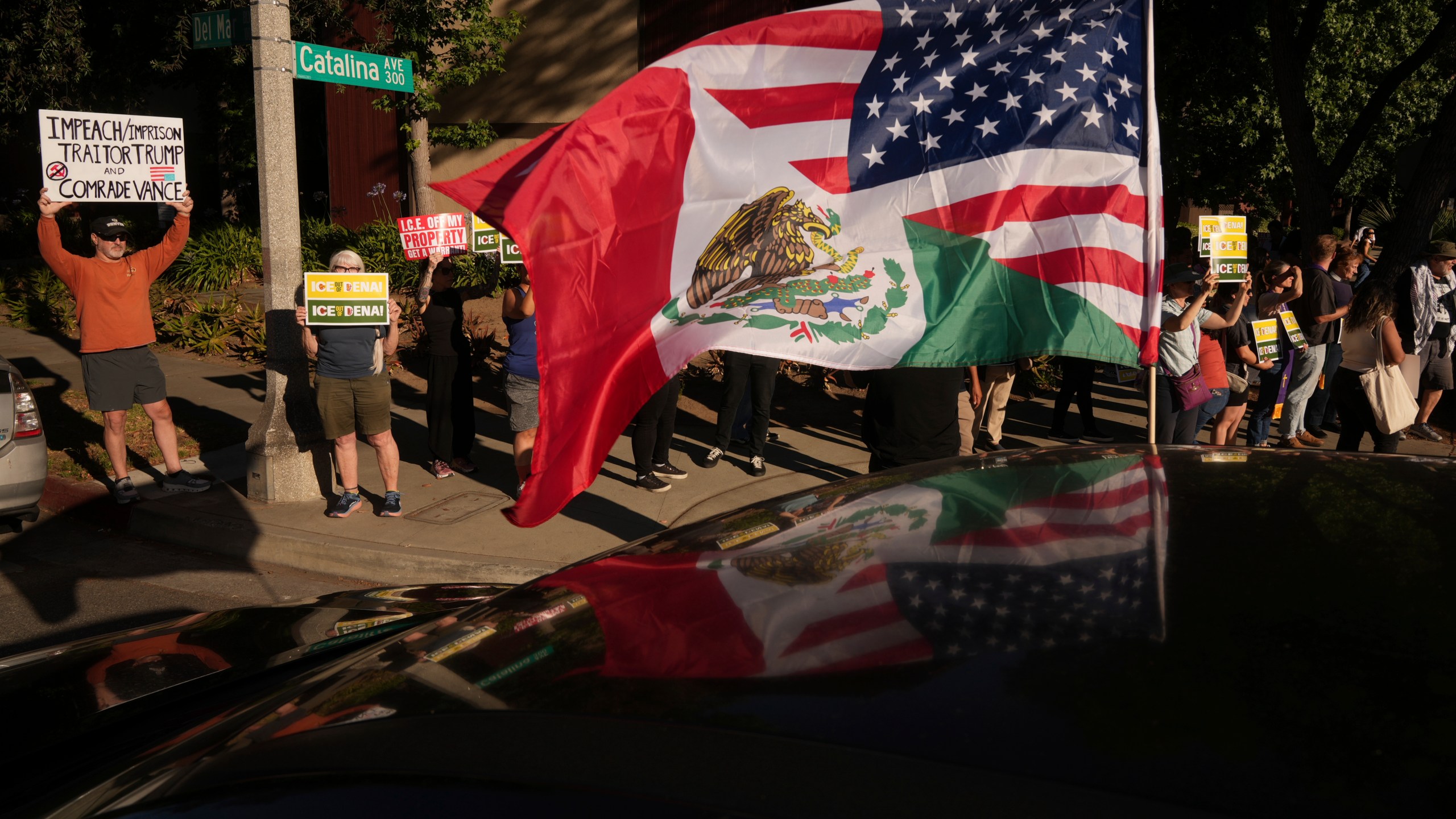 Residents gather during a community vigil on Monday, June 30, 2025, to stand in solidarity with an immigrant family after ICE agents detained Rosalina Luna Vargas on Saturday, June 28, in front of her children, in Pasadena, Calif. (AP Photo/Damian Dovarganes)