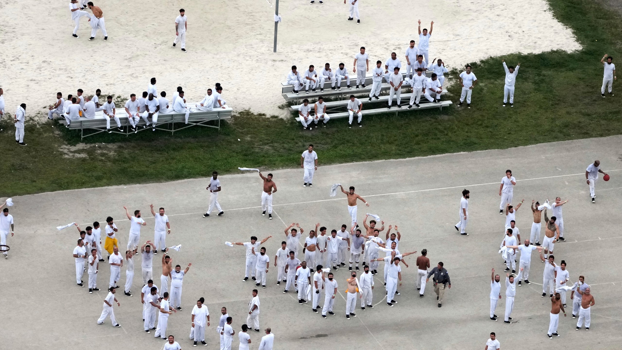 Detainees wave and spell out a rough SOS to a helicopter flying overhead, at U.S. Immigration and Customs Enforcement's Krome Detention Center, Friday, July 4, 2025, in Miami. (AP Photo/Rebecca Blackwell)
