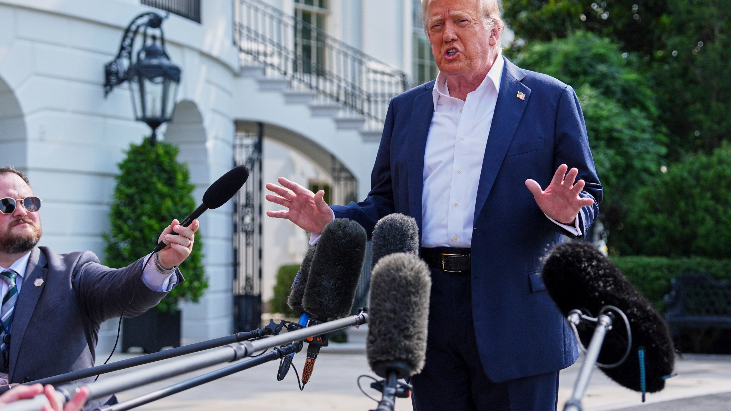 President Donald Trump speaks with reporters before departing the White House, Friday, July 11, 2025, in Washington. (AP Photo/Evan Vucci)