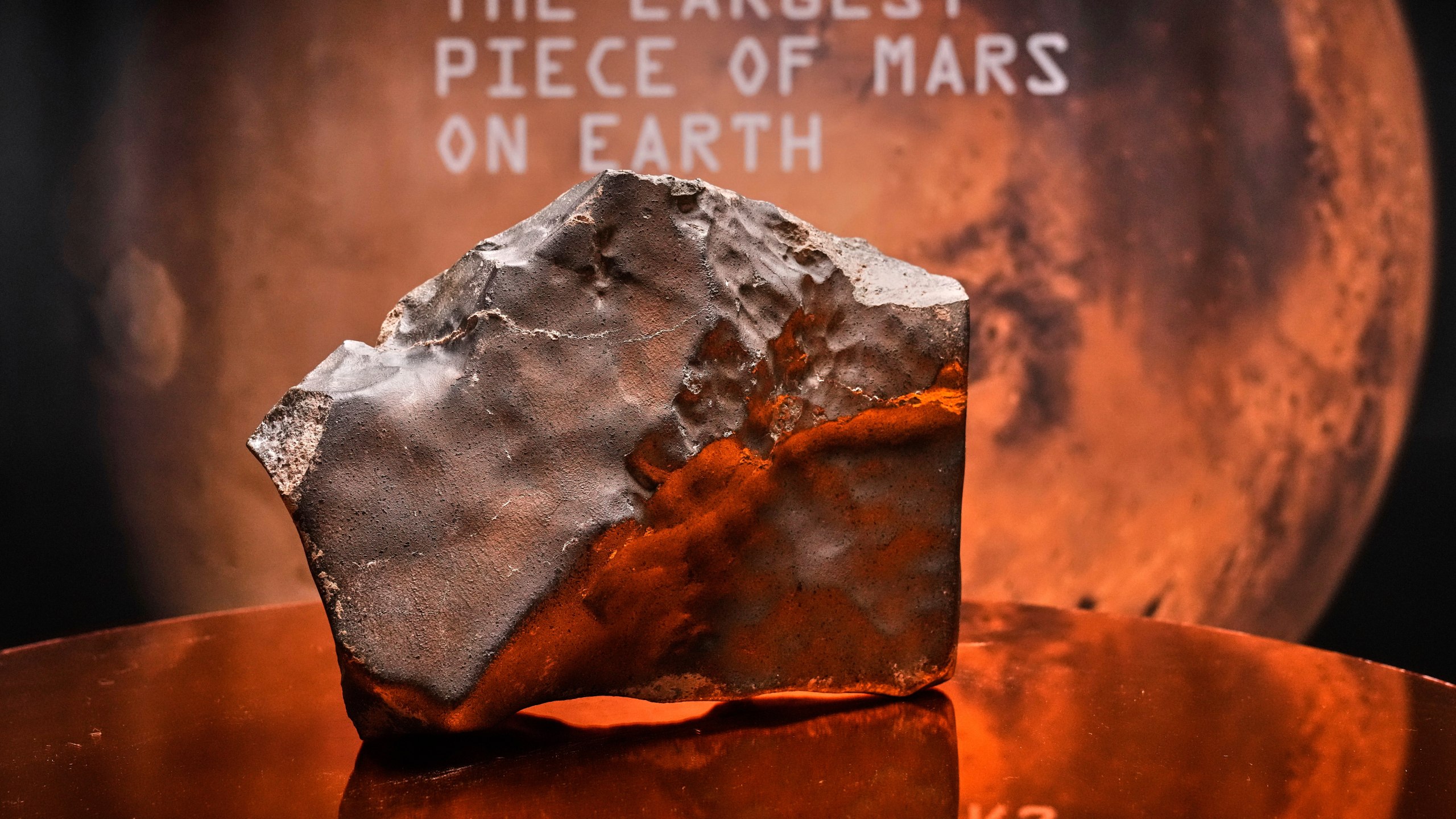 A Martian meteorite, weighing 54.388 lbs. (24.67 kg), said to be the largest piece of Mars on Earth, estimated at $2 - 4 million, is displayed at Sotheby's, in New York, Wednesday, July 9, 2025, part of their Geek Week auction, July 16, 2025. (AP Photo/Richard Drew)