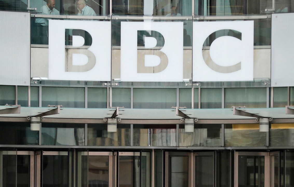 FILE - This photo shows a BBC sign outside the entrance to the headquarters of the publicly funded media organization in London, July 19, 2017. (AP Photo/Frank Augstein, File)