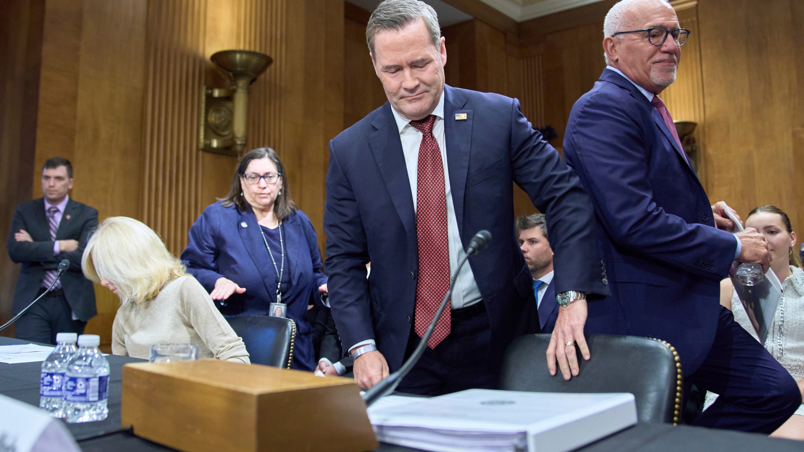Christine Toretti, left, nominee for U.S. Ambassador to Sweden, former White House National Security Adviser Michael Waltz, nominee for U.S. Representative to the United Nations, and John Arrigo, right, nominee for U.S. Ambassador to Portugal, arrive to a Senate Foreign Relations Committee nomination hearing, Tuesday, July 15, 2025, on Capitol Hill in Washington. (AP Photo/Jacquelyn Martin)