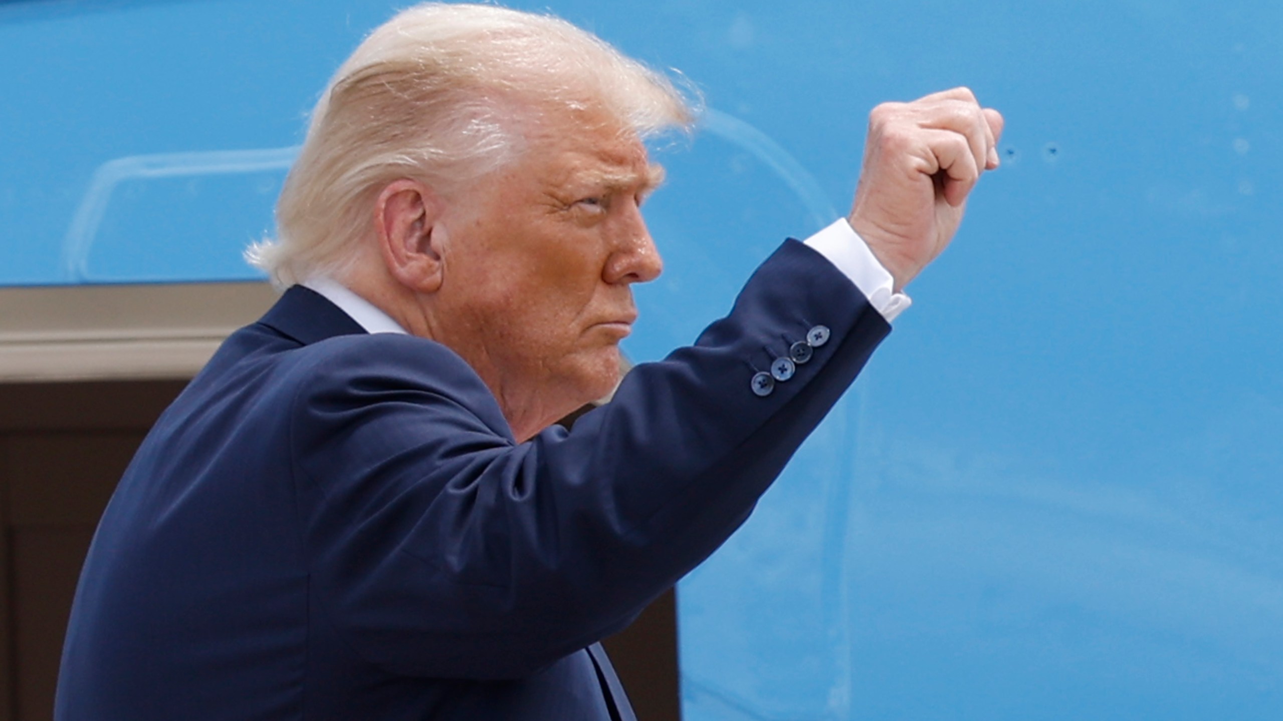 President Donald Trump gestures from the stairs of Air Force One as he boards upon his arrival at Joint Base Andrews, Md., Tuesday, July 15, 2025. (AP Photo/Luis M. Alvarez