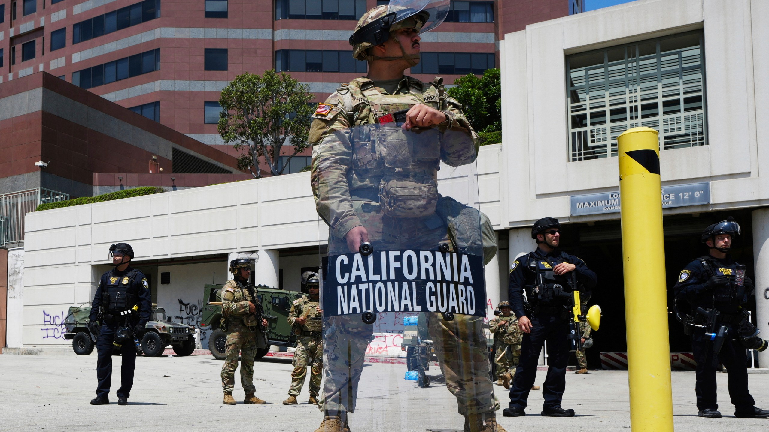 FILE - A California National Guardsmen stands to protect federal buildings, June 10, 2025, in Los Angeles. (AP Photo Damian Dovarganes, File)