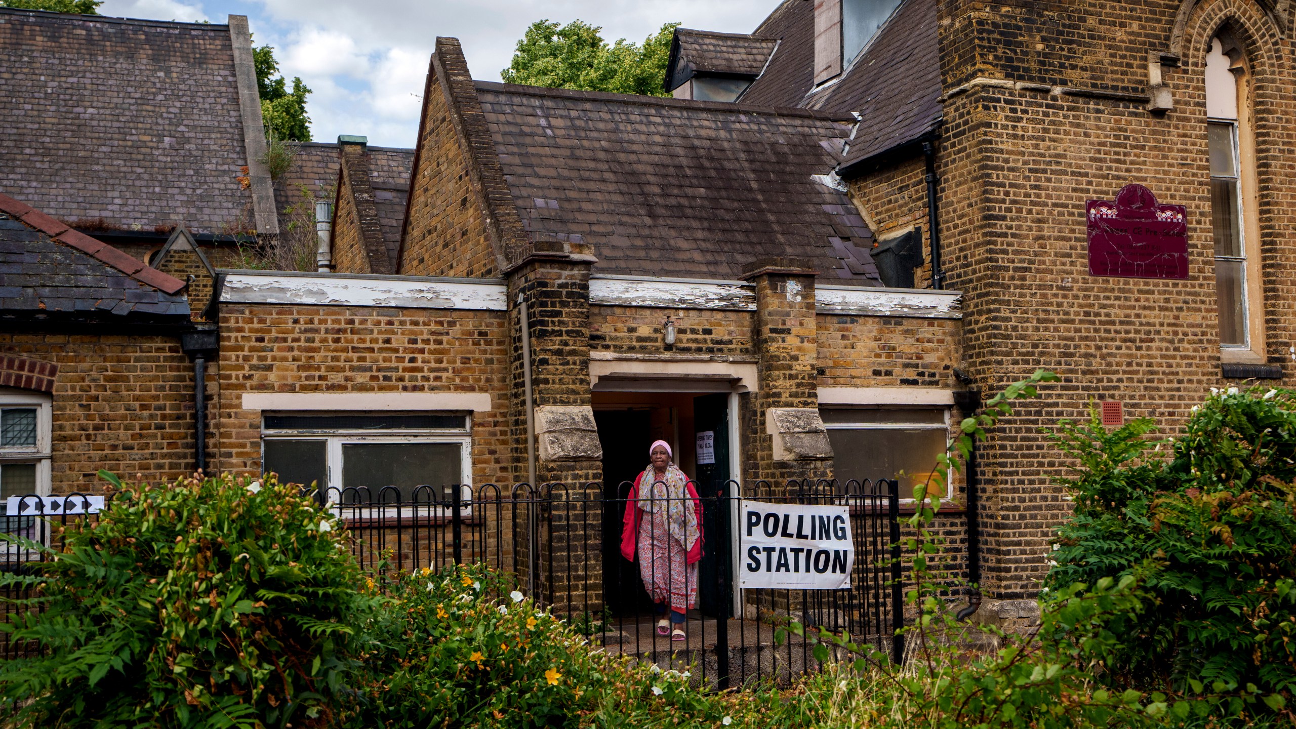FILE - A woman exits a polling station set up at St. Anne's Church, Bermondsey, in London, on July 4, 2024. (AP Photo/Vadim Ghirda, File)