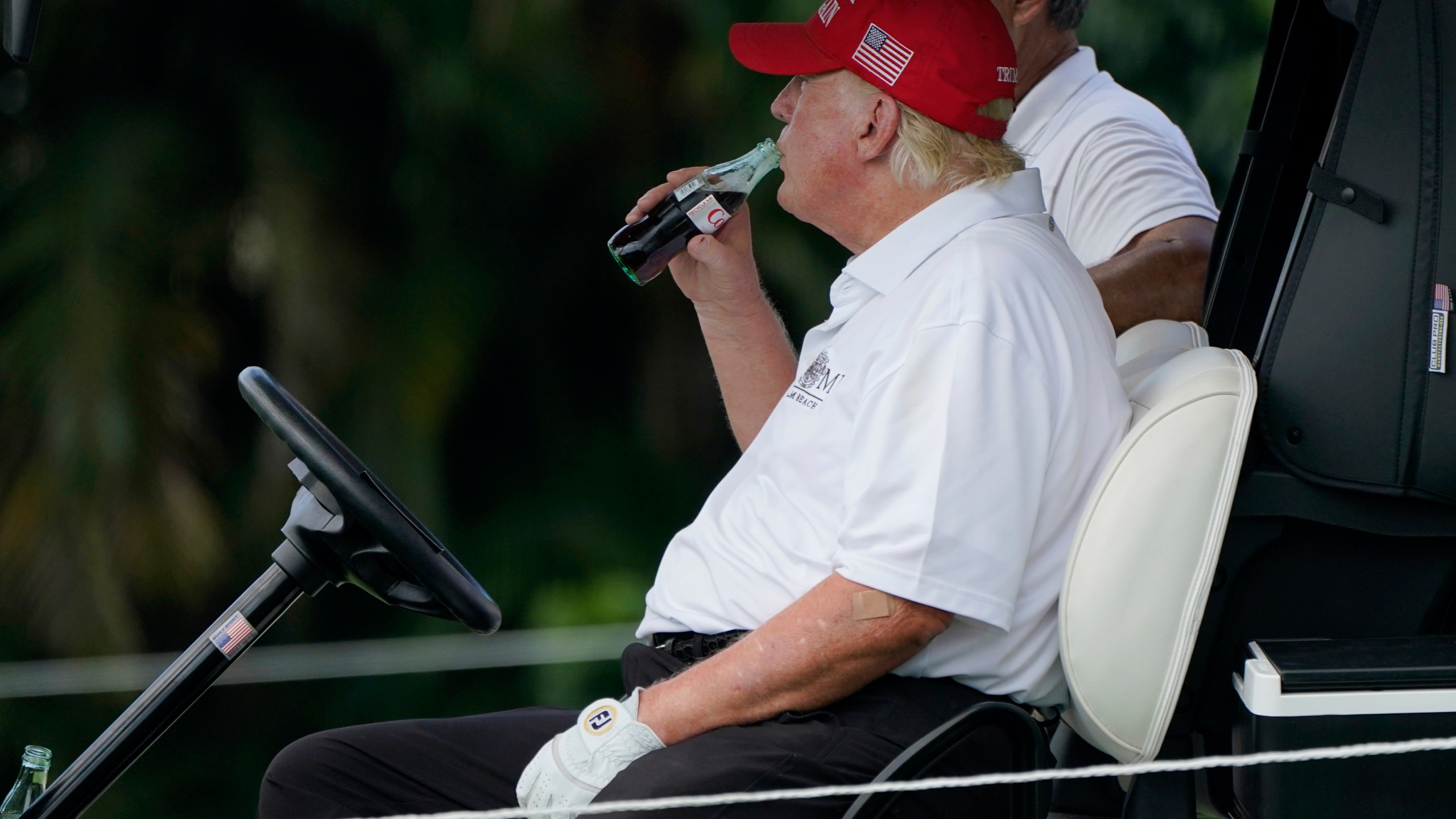 FILE - Former President Donald Trump drinks a Diet Coke during the ProAm of the LIV Golf Team Championship at Trump National Doral Golf Club, Oct. 27, 2022, in Doral, Fla. (AP Photo/Lynne Sladky, File)