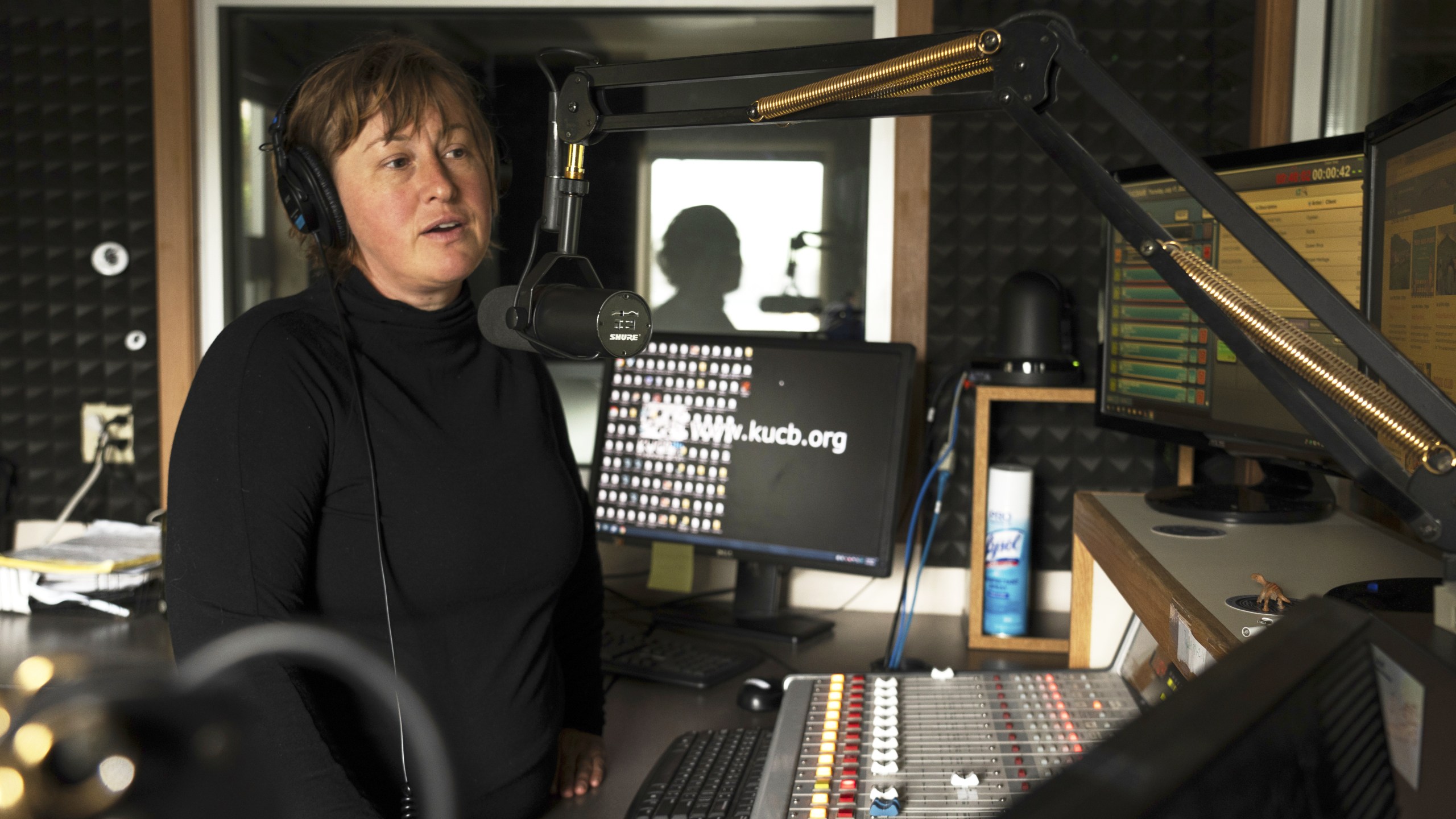 This photo provided by Kanesia McGlashan-Price shows Lauren Adams, general manager of public radio station KUCB in Unalaska, Alaska, in the broadcast studio Thursday, July 17, 2025. (Kanesia McGlashan-Price via AP)