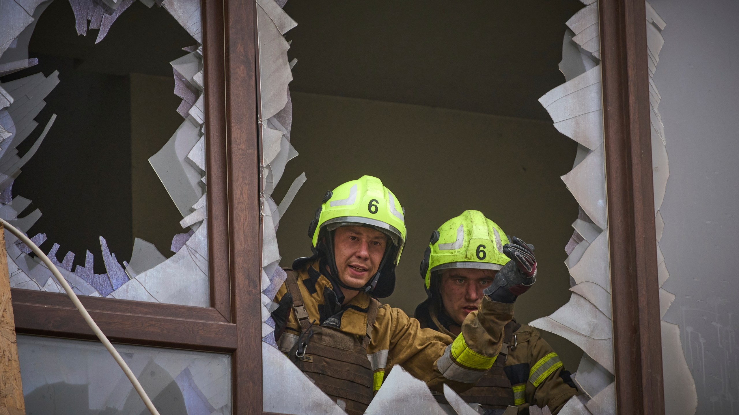 Firefighters work in a destroyed apartment building after a Russian attack in Kyiv, Ukraine, Monday, July 21, 2025. (AP Photo/Efrem Lukatsky)
