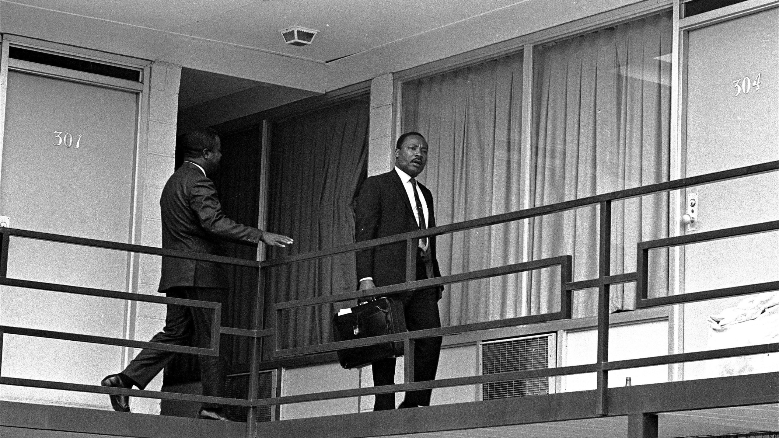 FILE - Rev. Martin Luther King, Jr. walks across the balcony of the Lorraine Motel in Memphis, April 3, 1968. (AP Photo/Charles Kelly, File)
