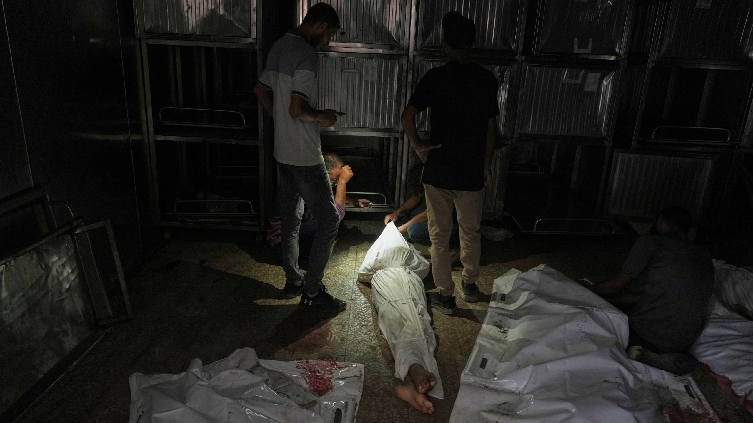 Palestinians mourn relatives killed in an Israeli army bombardment of Gaza at the morgue of Shifa Hospital in Gaza City Tuesday, July 22, 2025. (AP Photo/Jehad Alshrafi)