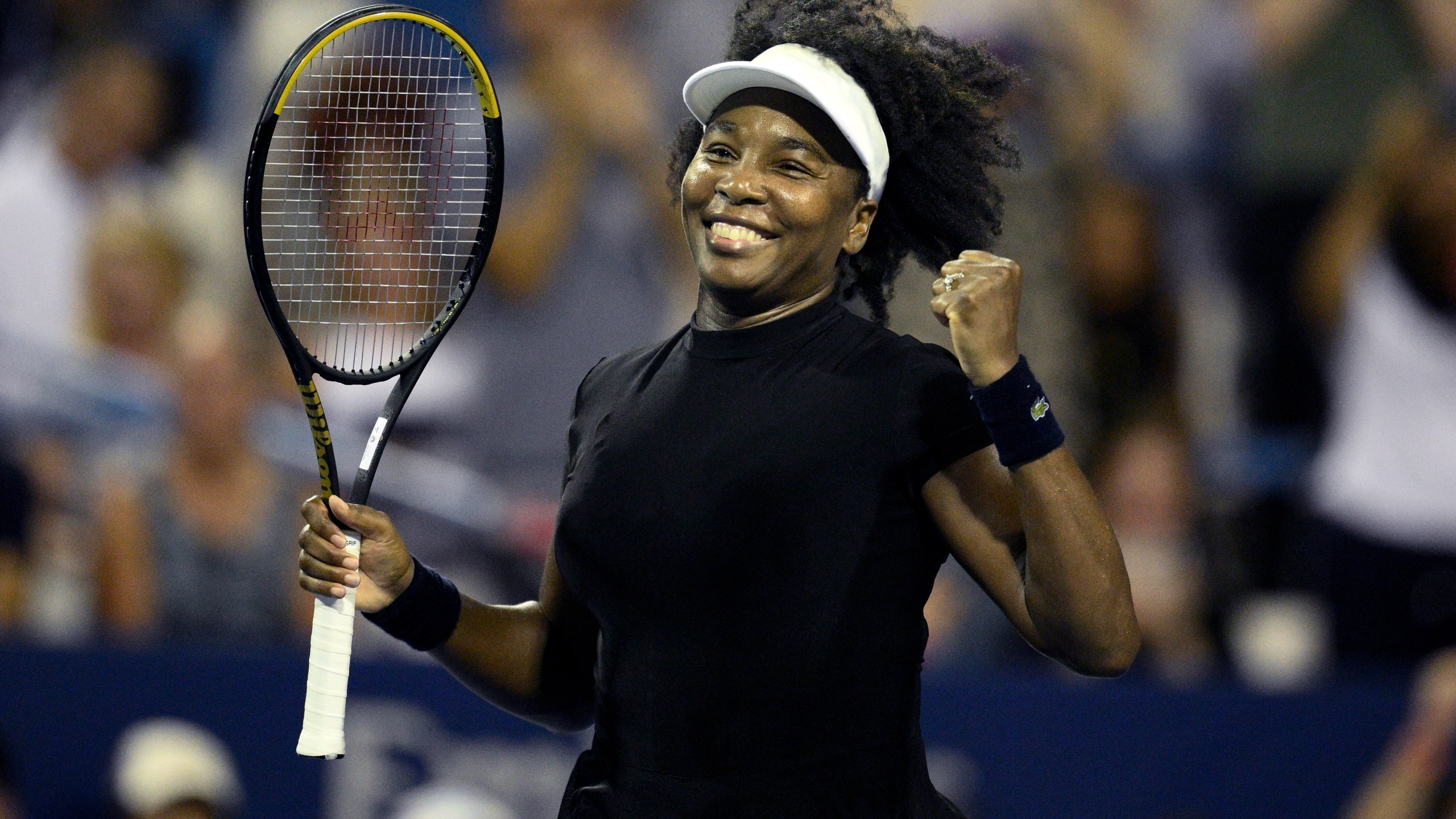 Venus Williams smiles and pumps her fist after a match