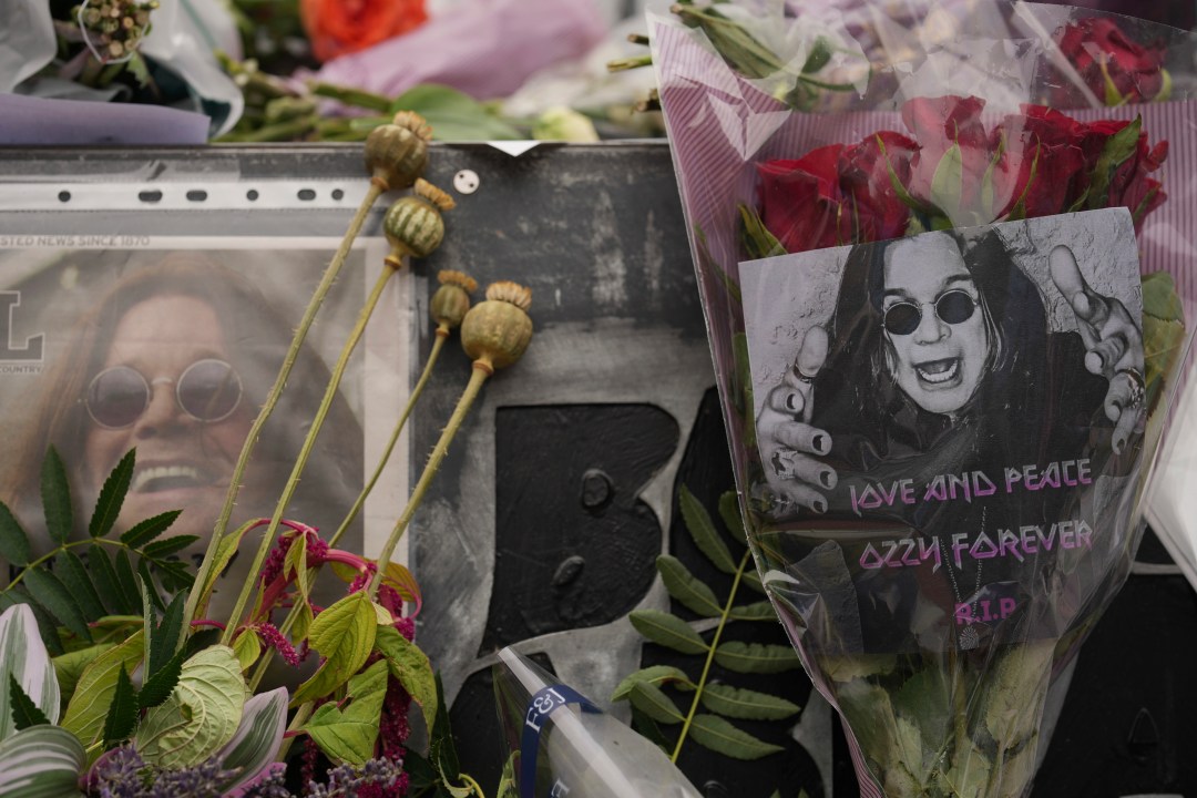 Flowers and messages are left by fans to commemorate the death of Ozzy Osbourne at the Black Sabbath Bridge in Birmingham, Wednesday, July 23, 2025. (AP Photo/Kin Cheung)